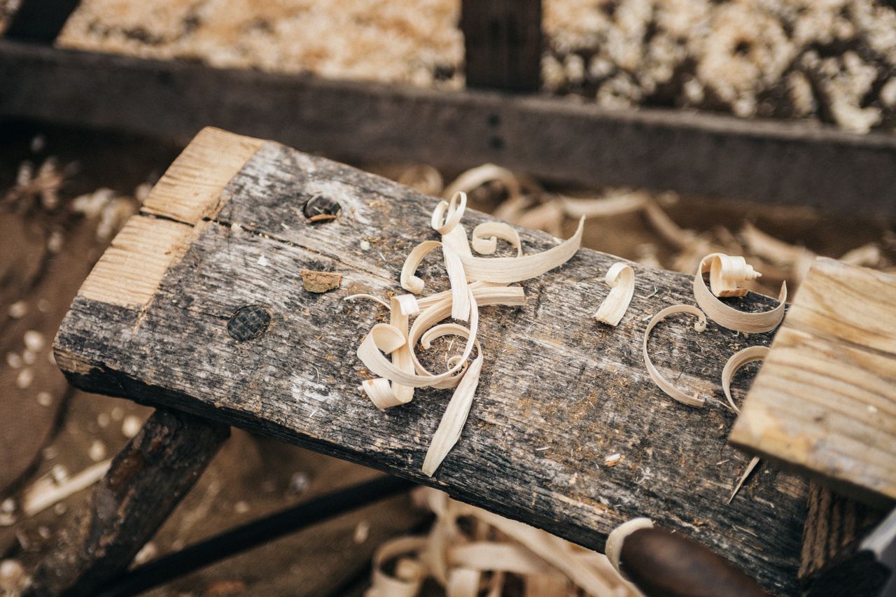The Art of Drawing Readers In: Your attractive post title goes here Rustic workbench covered in wood shavings, showcasing detailed craftsmanship.