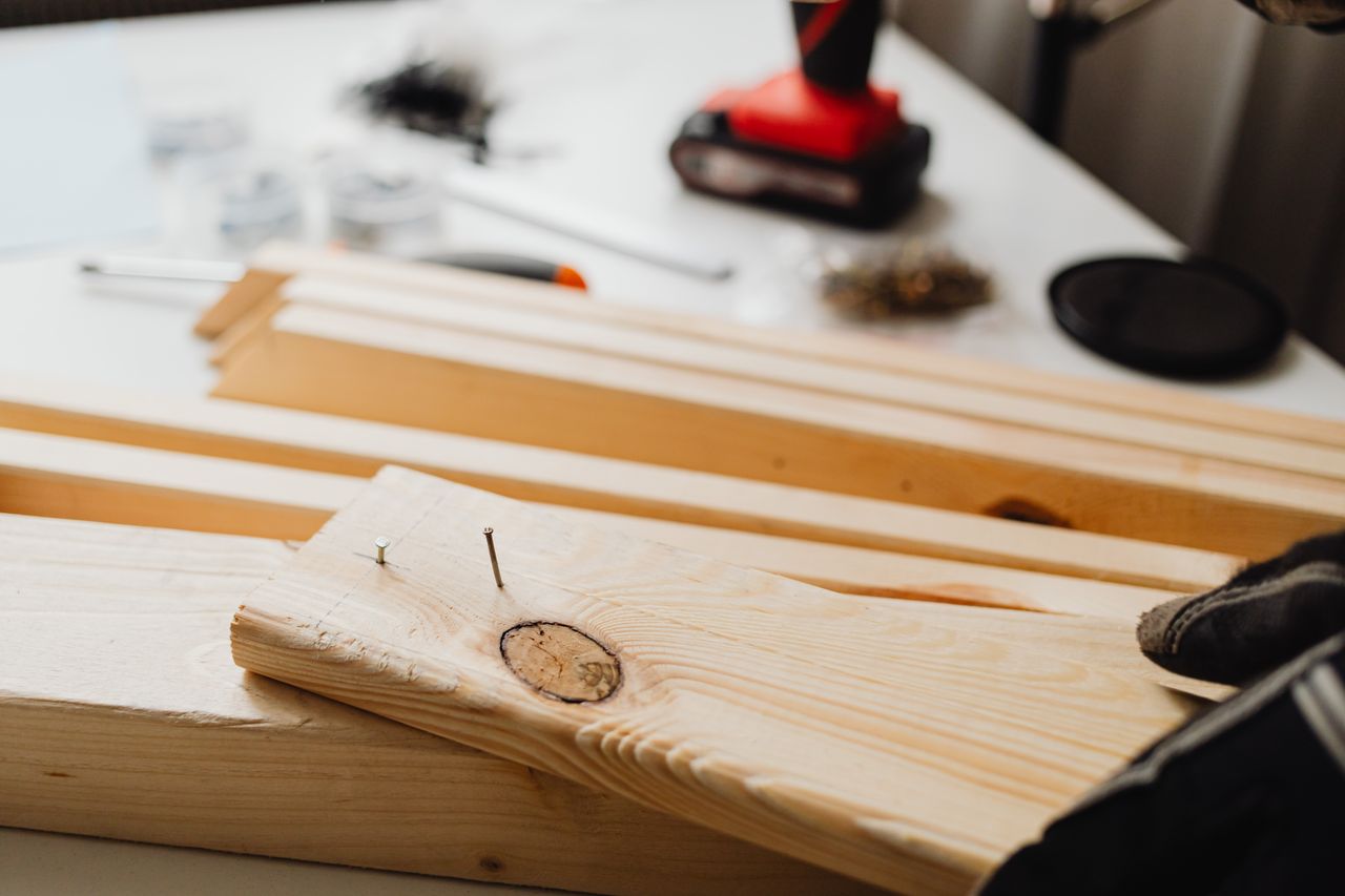Mastering the First Impression: Your intriguing post title goes here Close-up of woodworking, showing a power drill and wooden planks for DIY projects.